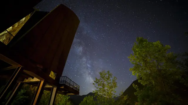 Observatoire astronomique sous un ciel étoilé avec des arbres en arrière-plan