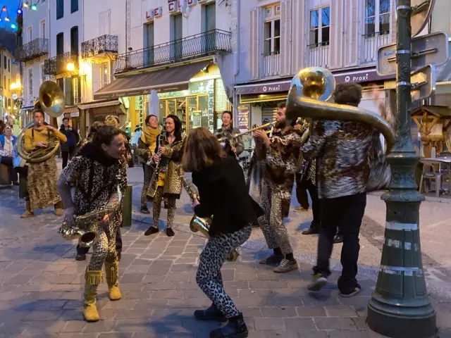 Group of people in costumes playing music on a street