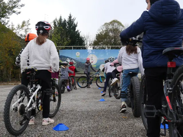 A group of kids learning to ride bikes in a park