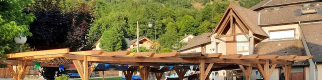 Mountain restaurant terrace with customers seated and potted plants