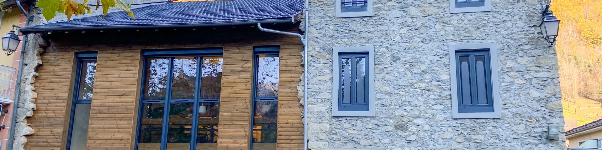 Bâtiment en pierre avec une façade moderne et des panneaux d'accessibilité