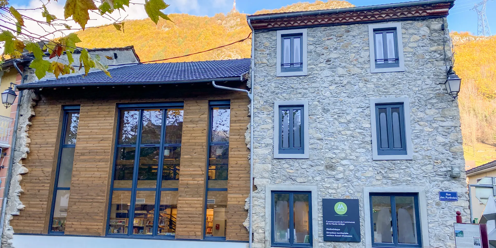 Stone building with a modern facade and accessibility signs