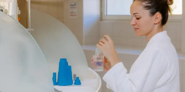 Woman in a white coat preparing a medical treatment