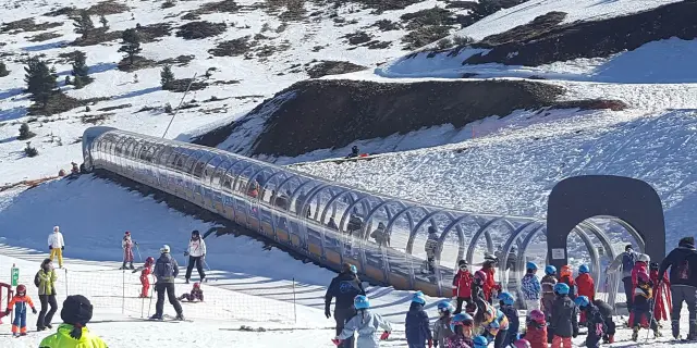 Téléski enneigé avec des skieurs et des enfants