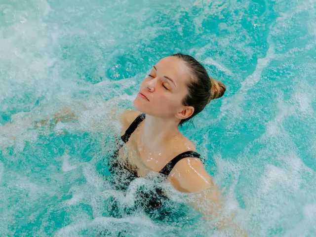 Relaxed woman in a bubbly hot tub