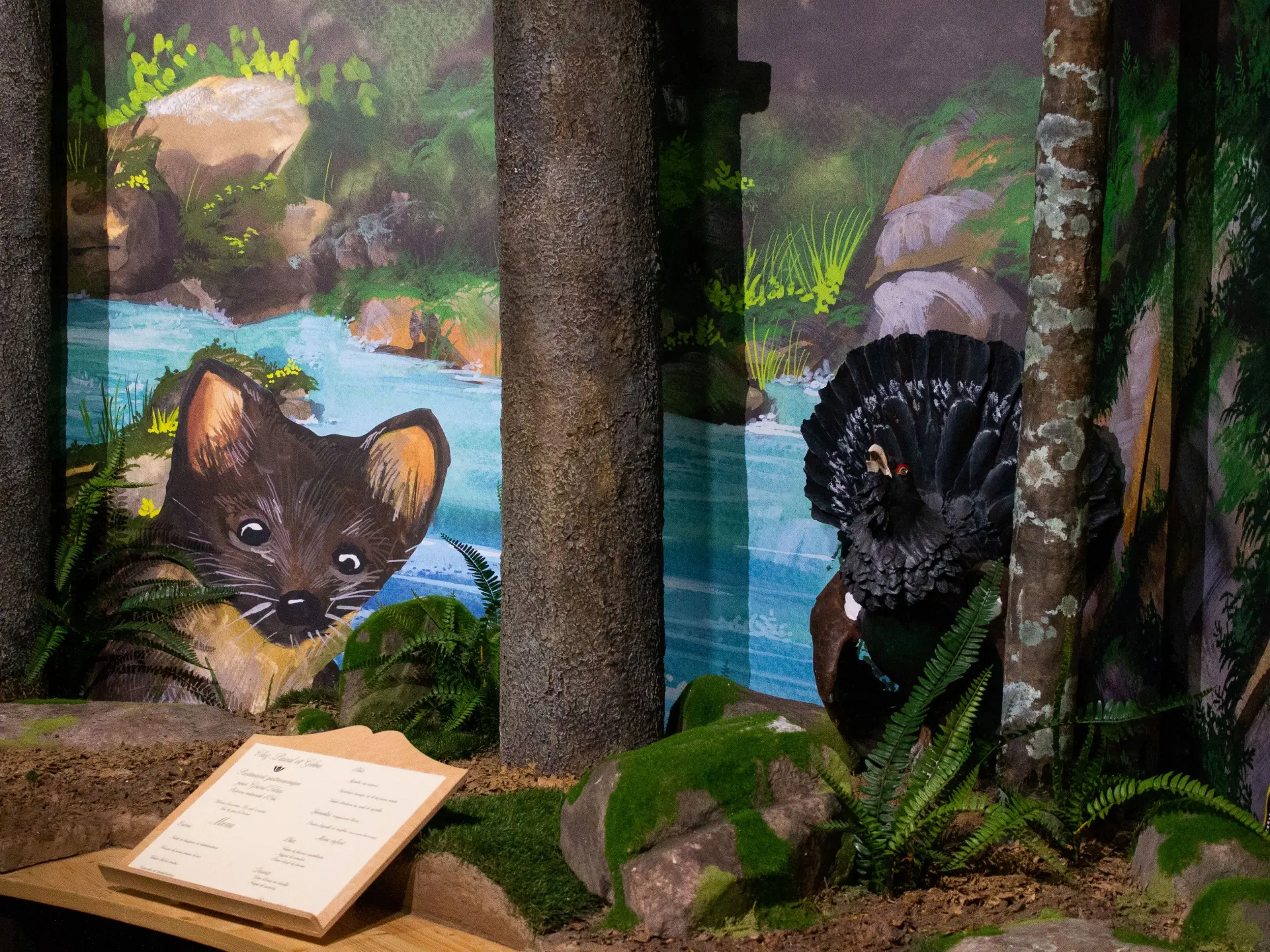 Two felines in a simulated environment with rocks and plants