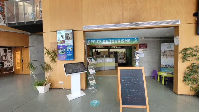 Entrance of a tourist office with signs and posters