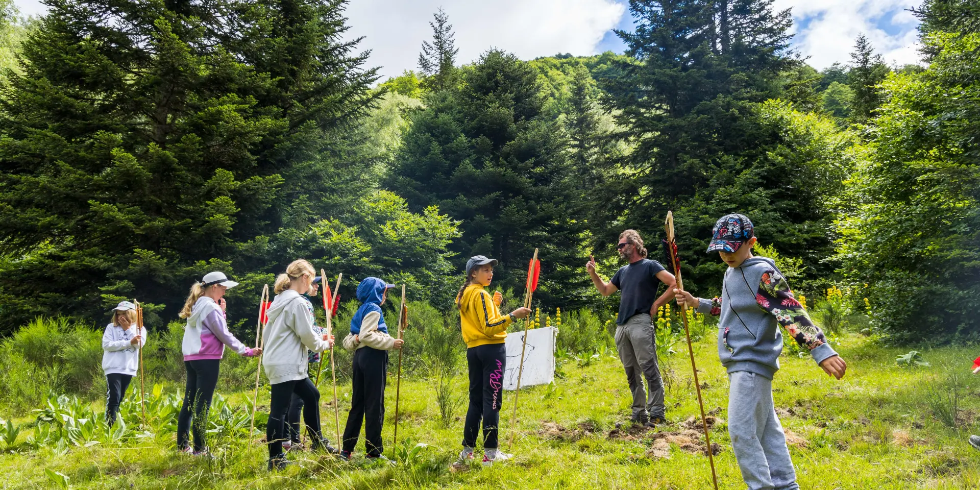 A group of people hiking in a green forest