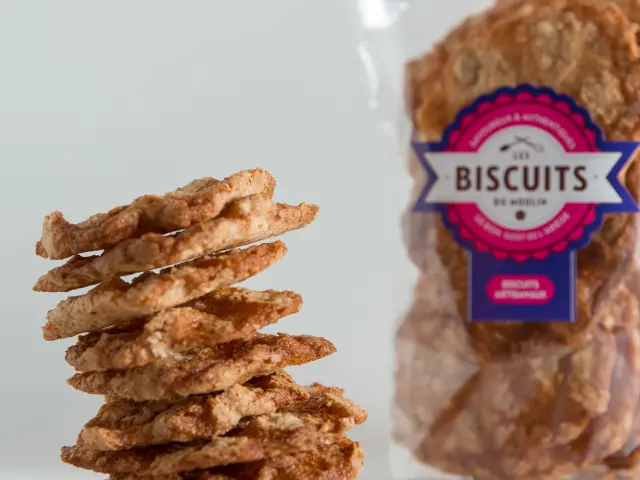 Package of crunchy biscuits with a stack of biscuits next to it