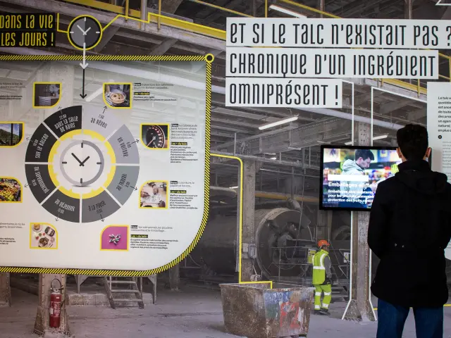 Person studying a talc exhibition in a factory