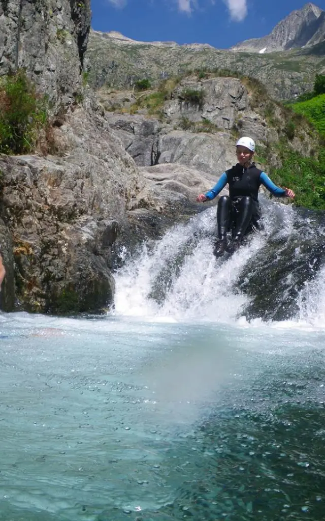Two people canyoning in a mountain river