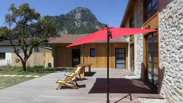 Terrasse en bois avec parasol rouge et chaises longues