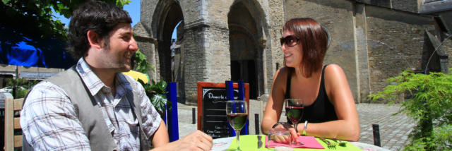 Couple atablé à la terrasse d'un restaurant sur la place de la Cathédrale d'Oloron Sainte-Marie