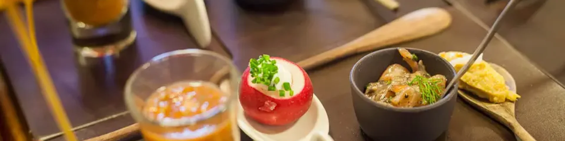 Assortiment de petites bouchées et verrines disposées sur une table.