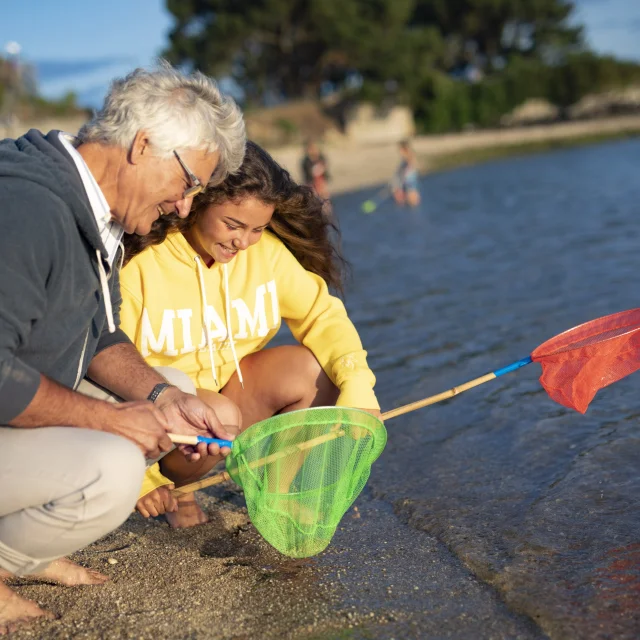 Family with landing nets for shore fishing