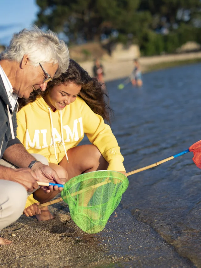 Family with landing nets for shore fishing