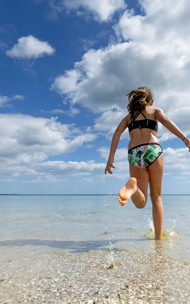 Young girl running for a swim