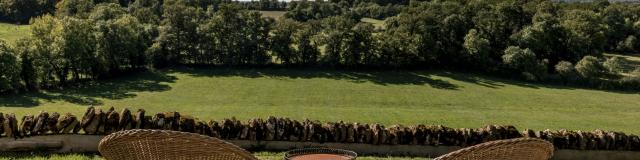 Deux fauteuils de type Loveuses face à la nature et un mur de pierres au Château de Labro