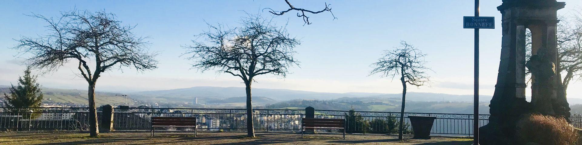 Square Bonnefé avec le buste en bronze du docteur Bonnefé devant son autel en pierre, avec son esplanade sableuse et ses bancs installés entre des arbres ace à la vue dégagée sur les alentours de Rodez