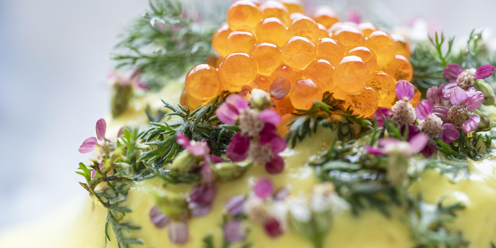Plat gastronomique concocté par le chef Hervé Busset, décoré avec des fleurs