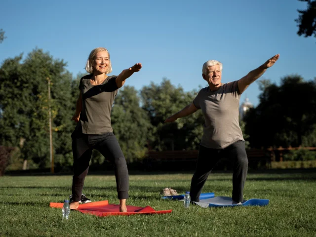 Mature Couple Practicing Yoga Outside