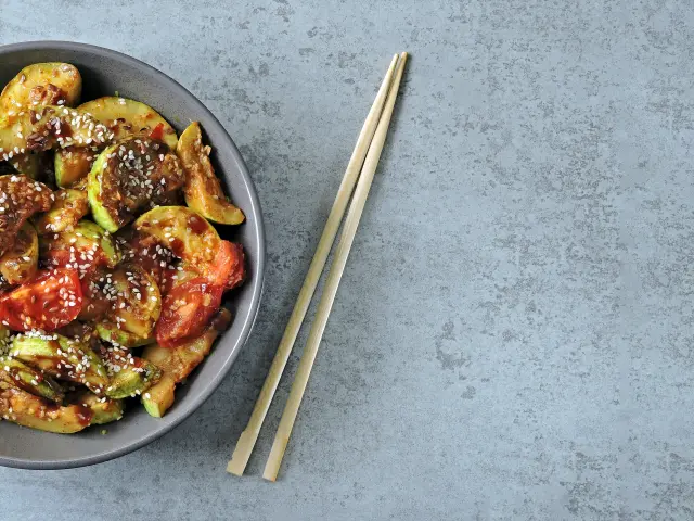Stewed zucchini with soy sauce and sesame. Squash in Chinese style.