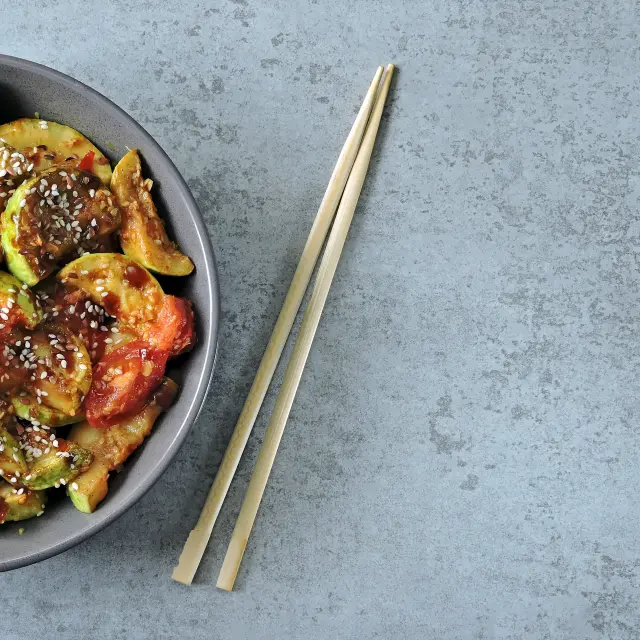 Stewed zucchini with soy sauce and sesame. Squash in Chinese style.
