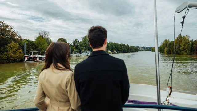 Couple entrain de regarder la seine pendant une croisière