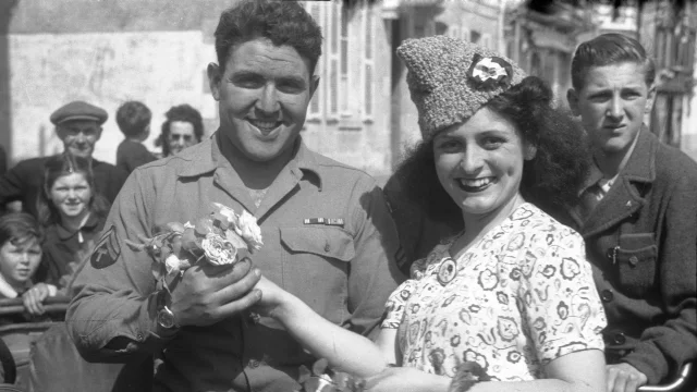 Une femme accueille un soldat américain avec des fleurs au Pouliguen, lors de la libération de la poche de Saint-Nazaire, le 11 mai 1945.