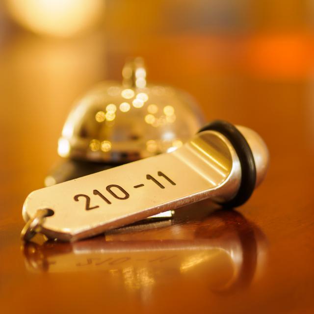 Reception - Hotel bell and key lying on the desk