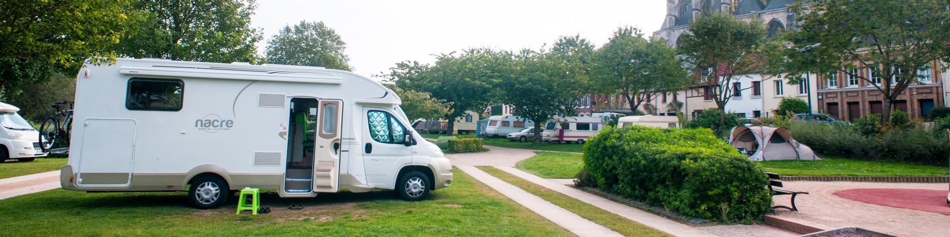 photo of a camper van park overlooked by the pont de l'arche church