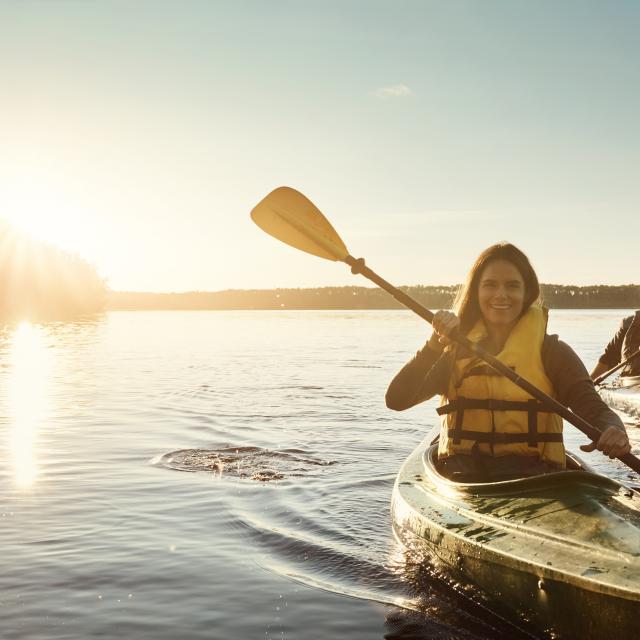 Shot of a young couple kayaking on a lake outdoors
