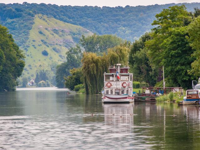 Photo du bateau Guillaume le conquérant à quai sur la seine avec canards et arbres feuillus à Poses en Normandie
