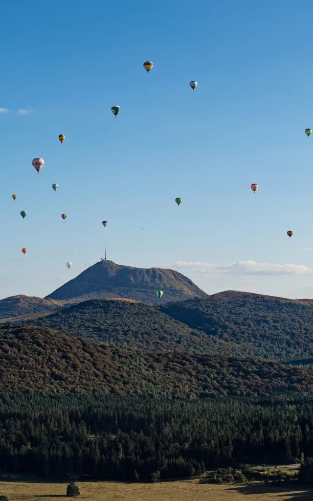 Vue sur les volcans de la chaîne des puys avec montgolfières depuis le puy des Gouttes à Saint-Ours-les-Roches