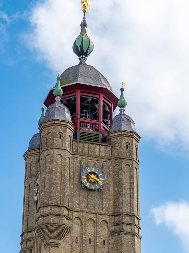 Belfry and its clock with blue sky