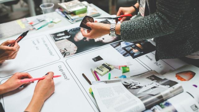Colleagues Working Together In Advertising Agency