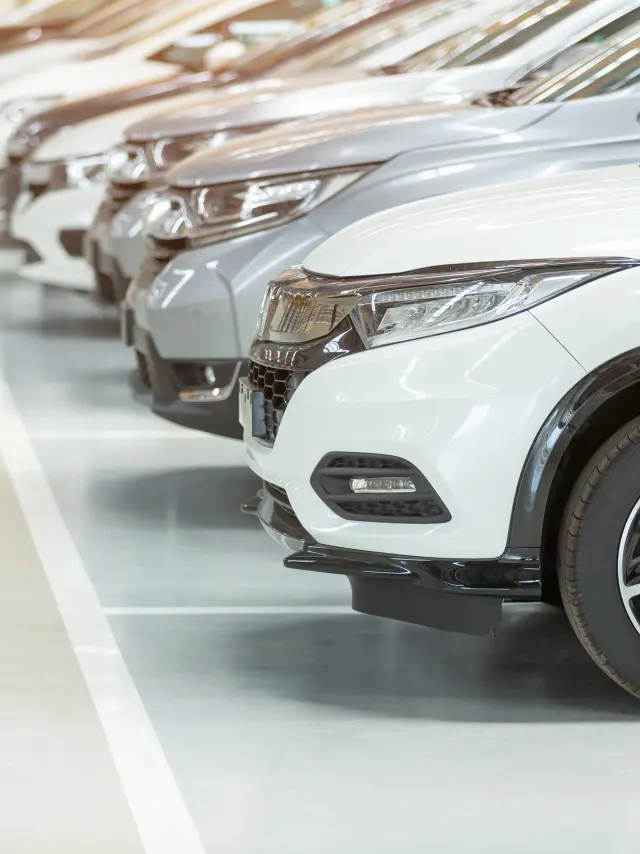 Cars For Sale, Automotive Industry, Cars Dealership Parking Lot. Rows of Brand New Vehicles Awaiting New Owners, on the epoxy floor in new car service
