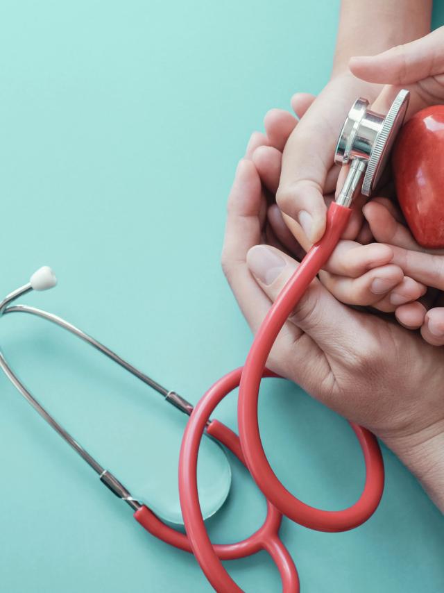 Family hands holding red heart with stethoscope, heart health,  health insurance concept, World heart day, world health day