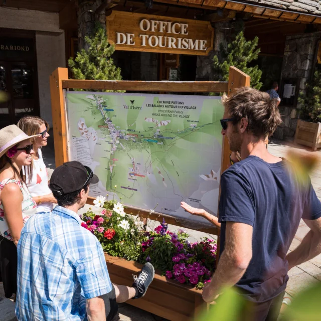 Val d'Isère Tourist Office in summer and its village map