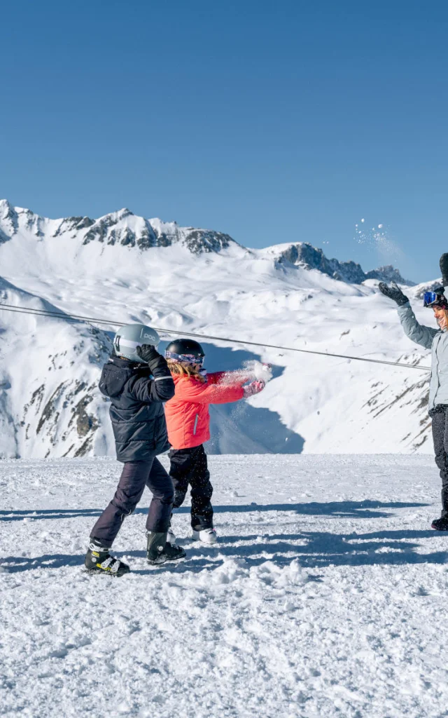 Family with children having fun in the snow Solaise in Val d'Isère