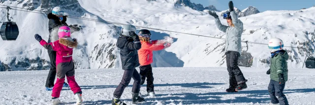 Family with children having fun in the snow Solaise in Val d'Isère