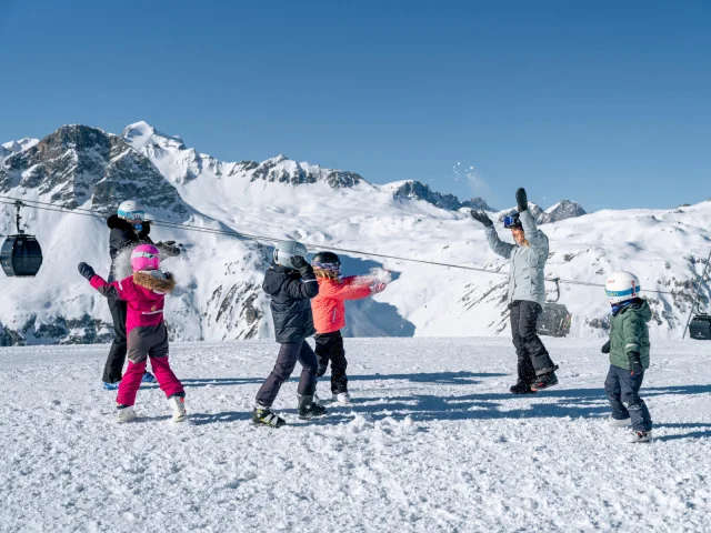 Family with children having fun in the snow Solaise in Val d'Isère