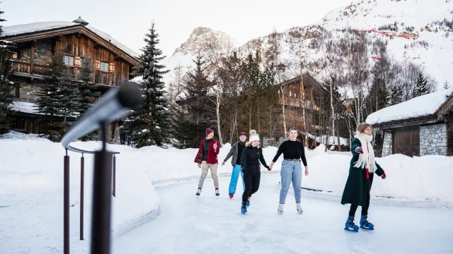 Group of friends at the skating rink in the heart of the village