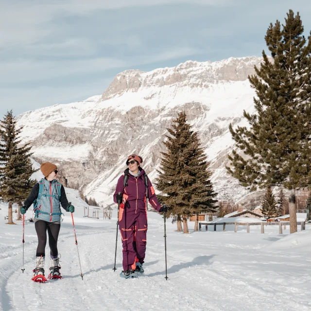 Two friends snowshoeing in winter in Val d'Isère's Manchet valley