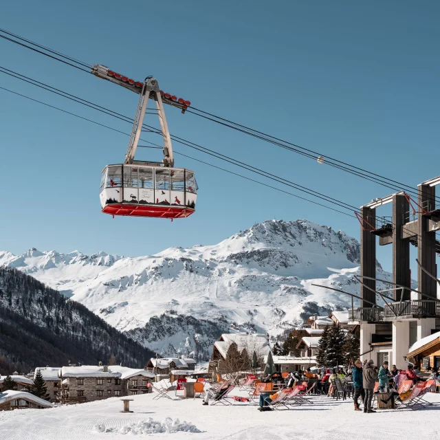 Fornet cable car in winter with sunshine and Les Crozets restaurant in Val d'Isère