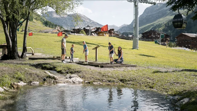 Family mini golf (parents and children) on the Val d'Isère green front in summer