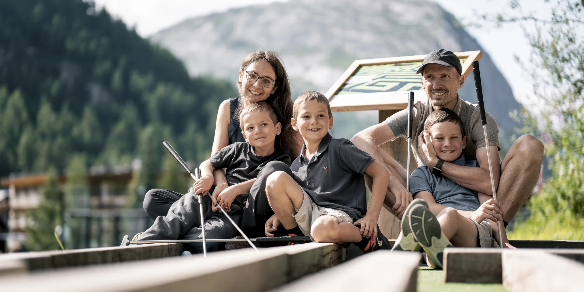 Family mini golf (parents and children) on the Val d'Isère green front in summer