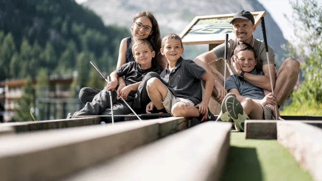 Family mini golf (parents and children) on the Val d'Isère green front in summer