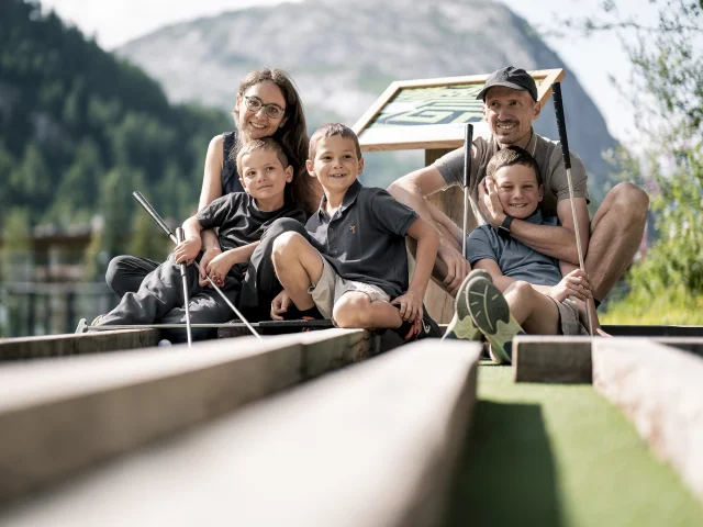 Family mini golf (parents and children) on the Val d'Isère green front in summer