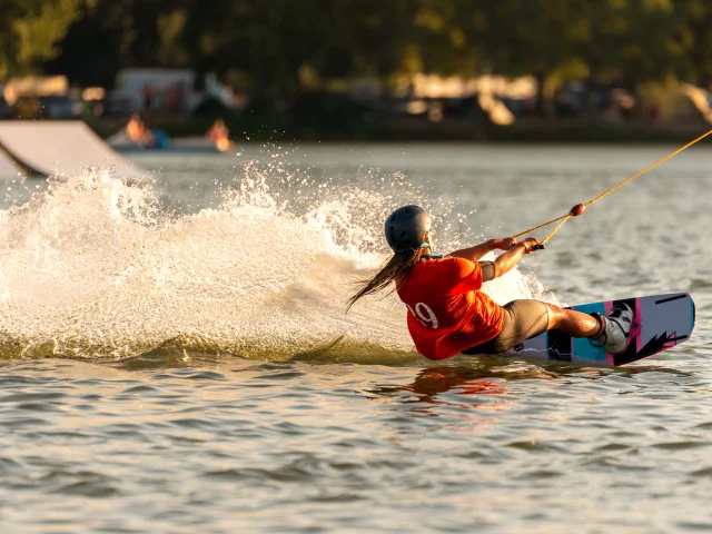 Young active woman on the wakeboard in cable park Merkur, Nove Mlyny, South Moravia, Czech Republic